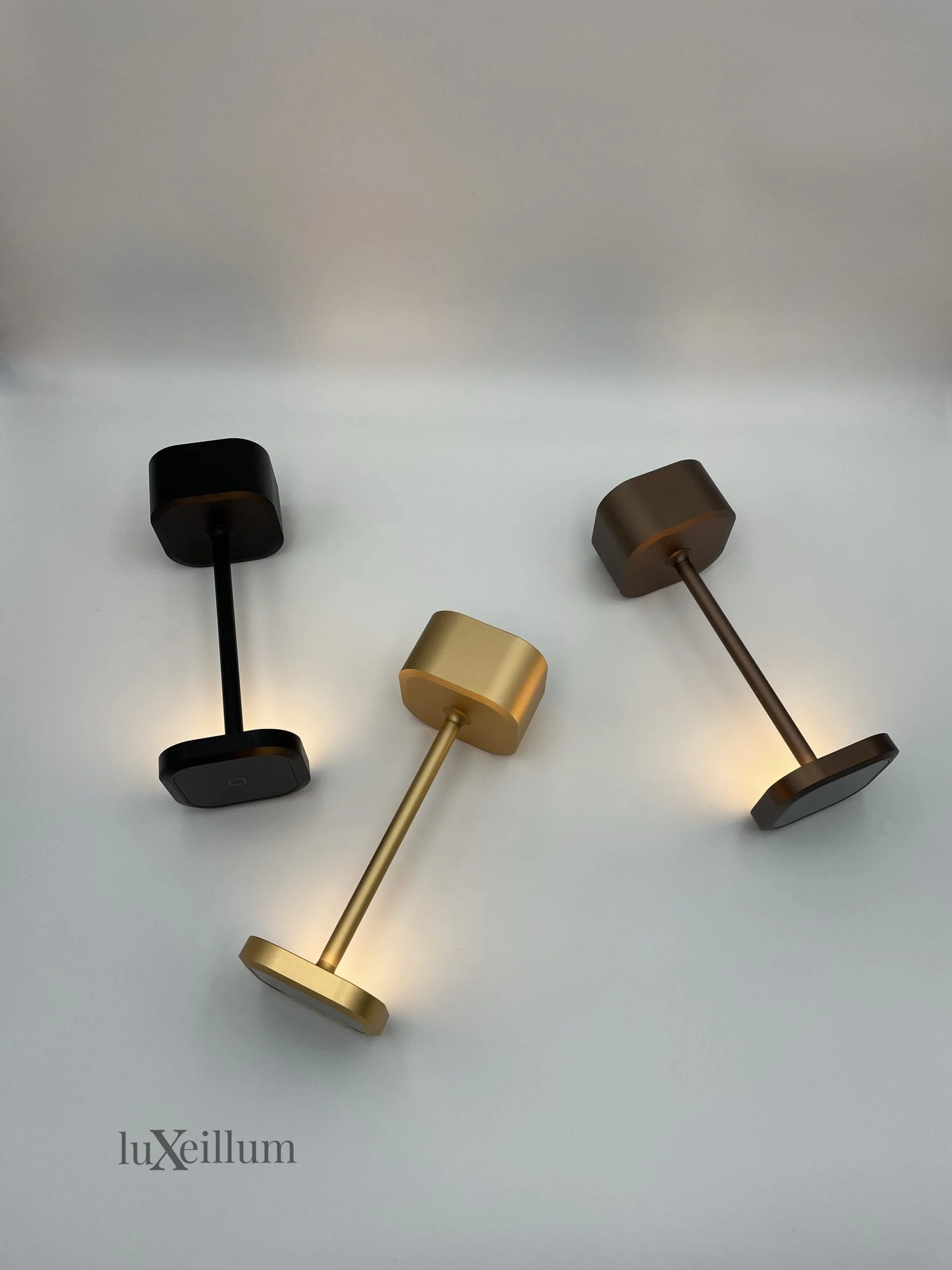 Elegant dining setup with black and bronze Luxeillum lamps