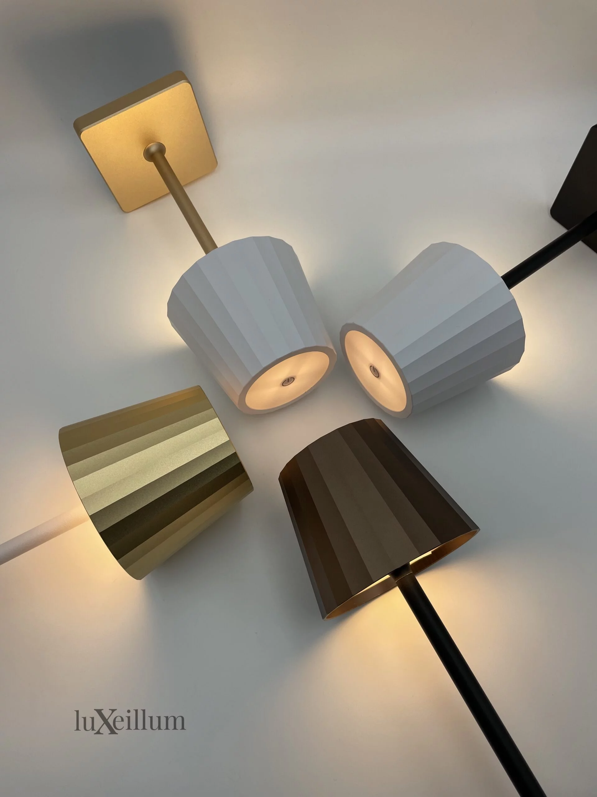 Matte gold hospitality-grade table lamp on white linen tablecloth