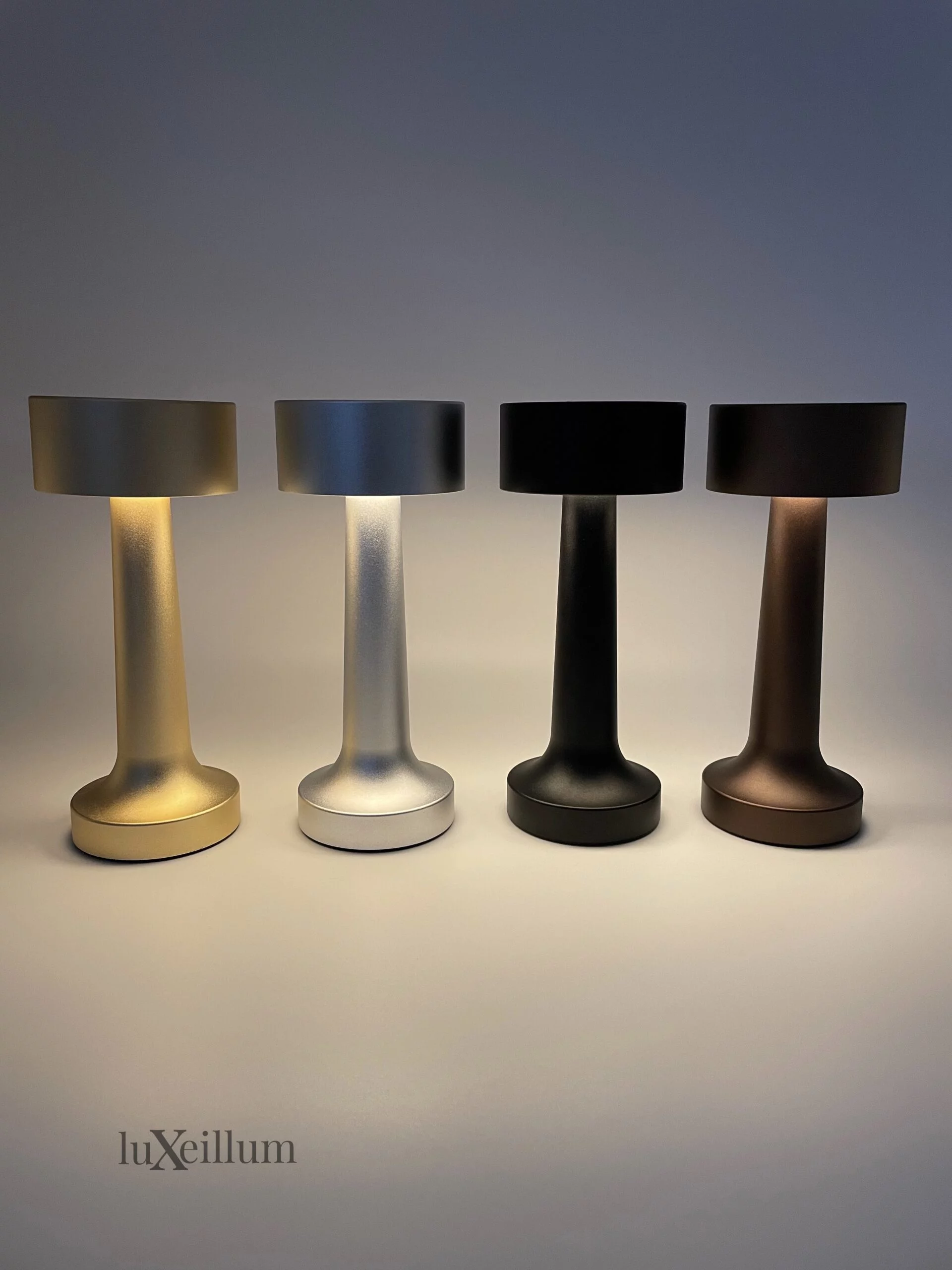 Luxury bistro tables lit with gold Luxeillum cordless lamps